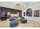 Bright primary suite with a dark accent wall, modern chandelier, and large arched window for ample natural light at 62 Incline Village Ct, Henderson, NV 89074