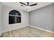 Bright bedroom featuring an arched window, hardwood floors, and neutral walls at 62 Incline Village Ct, Henderson, NV 89074