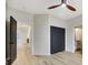 Neutral bedroom with hardwood floors, ceiling fan, closet, and view to an ensuite bathroom and hallway at 62 Incline Village Ct, Henderson, NV 89074
