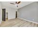 Bedroom with hardwood floors, ceiling fan, and multiple doorways at 62 Incline Village Ct, Henderson, NV 89074