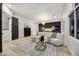 Bright open-concept primary suite boasts a sitting area, dark accent wall, modern lighting and large windows at 62 Incline Village Ct, Henderson, NV 89074