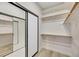 Organized closet with custom built-in shelving and mirrored sliding doors at 62 Incline Village Ct, Henderson, NV 89074