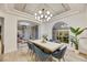 Dining area with modern lighting, sleek chairs, large windows, and views into the living room at 62 Incline Village Ct, Henderson, NV 89074