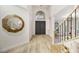 Welcoming home entryway featuring soaring ceilings, tile flooring, and a stylish staircase at 62 Incline Village Ct, Henderson, NV 89074