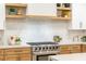 A modern kitchen features a stainless steel oven range and stone countertops at 62 Incline Village Ct, Henderson, NV 89074