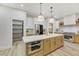Gourmet kitchen features an island, stainless steel appliances, and custom cabinetry at 62 Incline Village Ct, Henderson, NV 89074