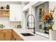 Modern kitchen features quartz countertops, stainless steel appliances, and an apron-front sink at 62 Incline Village Ct, Henderson, NV 89074