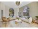Bright living room featuring neutral decor, large windows, modern furniture, and a stylish light fixture at 62 Incline Village Ct, Henderson, NV 89074