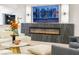 Living area featuring a modern fireplace and TV, plush seating, and contemporary decor at 62 Incline Village Ct, Henderson, NV 89074
