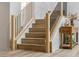 Bright staircase featuring wood treads, white risers, and sleek black metal balusters and natural wood returns at 62 Incline Village Ct, Henderson, NV 89074