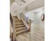 Staircase with light wood steps and black railings leading to the upper level of the home at 62 Incline Village Ct, Henderson, NV 89074