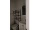 Bathroom showcasing a toilet, shelving unit, vanity and tiled shower at 621 Van Ert Ave, North Las Vegas, NV 89030