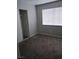 Bedroom features a closet with sliding doors, a window with blinds, and carpeted flooring at 621 Van Ert Ave, North Las Vegas, NV 89030