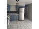 Kitchen features white appliances, blue cabinets, and white tiled floors at 621 Van Ert Ave, North Las Vegas, NV 89030