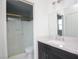 Bathroom featuring granite vanity, sink, framed mirror, vanity lighting, toilet, and a shower behind a glass door at 6215 Don Zarembo Ave, Las Vegas, NV 89108