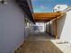 Side yard with concrete walkway and attached pergola at 6215 Don Zarembo Ave, Las Vegas, NV 89108