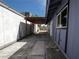 Side yard with concrete walkway and attached pergola at 6215 Don Zarembo Ave, Las Vegas, NV 89108