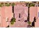 An overhead view reveals houses with clay tile roofs and outdoor patio furniture at 63 Via Di Mello, Henderson, NV 89011