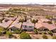 A high-angle view showcases homes with landscaped yards and golf course views at 63 Via Di Mello, Henderson, NV 89011