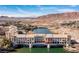 Picturesque aerial view of a lakeside community featuring a bridge and waterfront homes with scenic mountain backdrop at 63 Via Di Mello, Henderson, NV 89011
