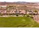 Aerial view showcasing a vibrant community adjacent to a lush golf course at 63 Via Di Mello, Henderson, NV 89011