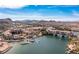 Beautiful aerial shot of a lakeside community featuring Mediterranean-style homes, boat docks, and desert views at 63 Via Di Mello, Henderson, NV 89011