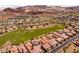 Stunning aerial view of the community, featuring homes, a golf course, and picturesque mountain views at 63 Via Di Mello, Henderson, NV 89011