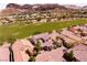 Stunning aerial view of a community near a golf course, surrounded by scenic desert mountains at 63 Via Di Mello, Henderson, NV 89011