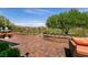Relaxing backyard features comfortable seating, brick planters, and beautiful landscaping at 63 Via Di Mello, Henderson, NV 89011