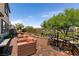 Outdoor living space with brick patio, comfortable seating, and a bar table set for entertaining at 63 Via Di Mello, Henderson, NV 89011