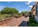 Private backyard oasis features a brick paver patio and lush green space at 63 Via Di Mello, Henderson, NV 89011