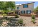 Spacious backyard with a wrought iron fence, lush greenery, and ample space for outdoor enjoyment at 63 Via Di Mello, Henderson, NV 89011