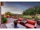 Landscaped backyard featuring outdoor seating, manicured greenery and desert mountain views at 63 Via Di Mello, Henderson, NV 89011