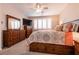Bedroom with ceiling fan, shuttered window, and dark wood dresser at 63 Via Di Mello, Henderson, NV 89011