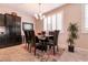Charming dining room featuring a glass table, elegant chandelier, and ample natural light at 63 Via Di Mello, Henderson, NV 89011