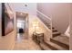 Inviting foyer with stairs and tile flooring, showcasing an entry to other rooms and an accent table at 63 Via Di Mello, Henderson, NV 89011