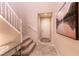 Welcoming entryway featuring a staircase with white banister and decorative floor tiles at the front door at 63 Via Di Mello, Henderson, NV 89011
