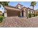 Well-maintained home featuring a Spanish tile roof, an attached two-car garage, and manicured landscaping at 63 Via Di Mello, Henderson, NV 89011