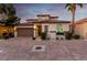 Beautiful two-story home featuring a Spanish tile roof, lush landscaping, and a spacious two-car garage at 63 Via Di Mello, Henderson, NV 89011