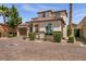 Charming two-story home with a Spanish tile roof, attached two-car garage, and neatly trimmed landscaping at 63 Via Di Mello, Henderson, NV 89011