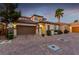 Beautiful two-story home featuring a Spanish tile roof, lush landscaping, and a spacious two-car garage at 63 Via Di Mello, Henderson, NV 89011