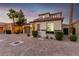 Inviting two-story home showcasing a Spanish-style roof, tidy landscaping, and an attached two-car garage at 63 Via Di Mello, Henderson, NV 89011
