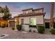 Charming two-story home boasts a tile roof, manicured landscaping, and a paver driveway at 63 Via Di Mello, Henderson, NV 89011