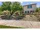 Beautiful home with mature trees and landscaping, offering shade and curb appeal at 63 Via Di Mello, Henderson, NV 89011