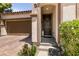 Inviting front entrance features a decorative wreath, custom front door, and manicured landscaping at 63 Via Di Mello, Henderson, NV 89011