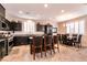 Well-lit kitchen featuring dark cabinetry, granite countertops, and stainless steel appliances at 63 Via Di Mello, Henderson, NV 89011