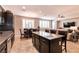 Open floor plan with kitchen island, dining area, and living room with comfortable sofa at 63 Via Di Mello, Henderson, NV 89011