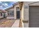 Close up of the front entrance and two car garage of a charming single story home at 6438 Rose Tree Ln, Las Vegas, NV 89156