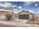 Single-story home boasting a two car garage and minimal desert landscaping at 6438 Rose Tree Ln, Las Vegas, NV 89156