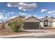 Lovely single story home showcasing a two car garage and desert landscaping in front at 6438 Rose Tree Ln, Las Vegas, NV 89156